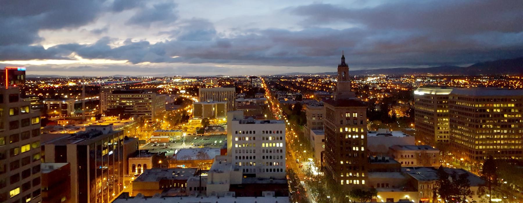 a city with buildings and a cloudy sky