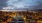 a city with buildings and a cloudy sky