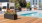 a pool with a planter and chairs by it