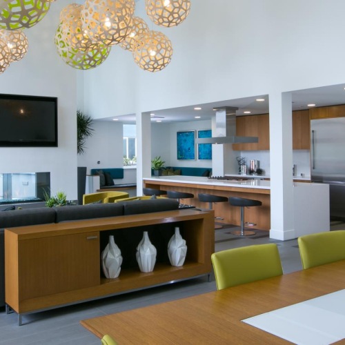 Find your perfect fit at Aire a room with a couch and a table with a television and chandelier