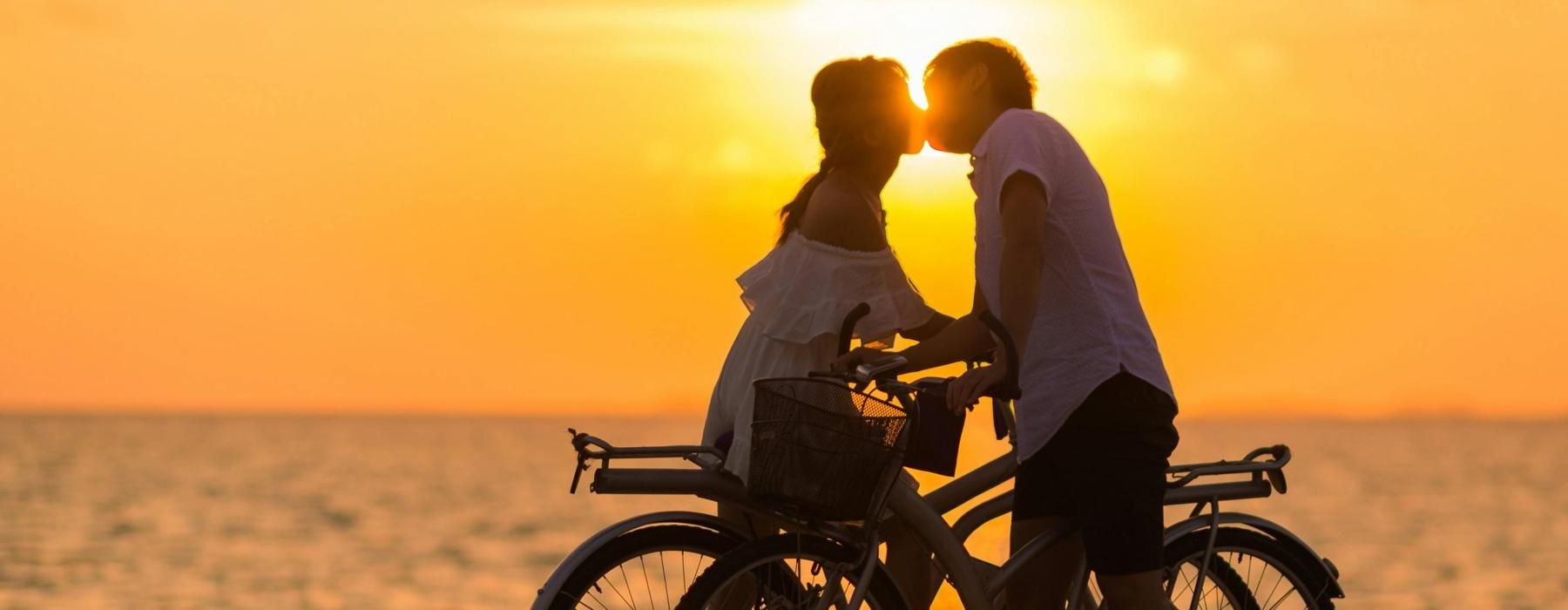 a man and woman on a bicycle